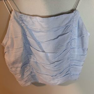 Super cute, light blue tank top. Size xs never worn and in fantastic condition.